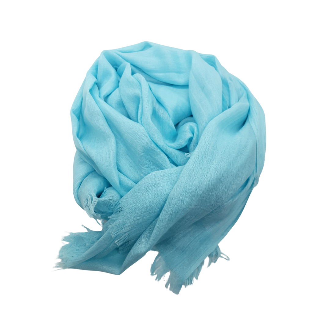 Beauty in Bamboo scarf in Electric Blue, a bright aqua-turquoise, gathered into a soft coil