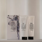 Salus Body Rescue Duo scrub and body cream tubes standing in front of the gift box