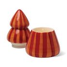 Red and orange striped tree candle with its top lifted off and set beside the base, showing the wax.