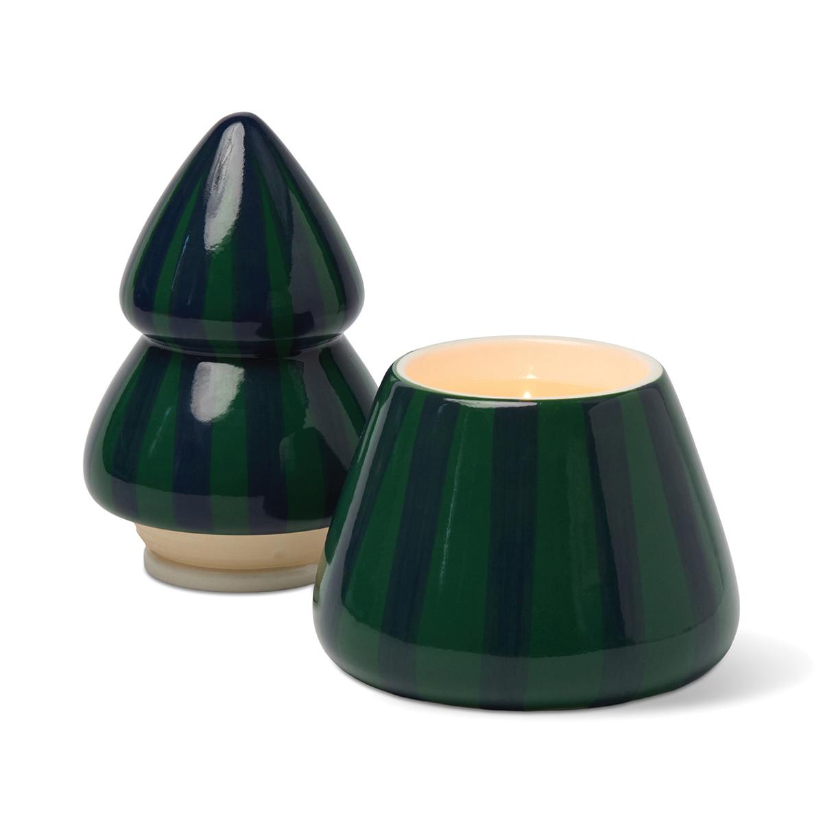 Dark green and navy striped tree candle with its top set beside the base, showing the wax.