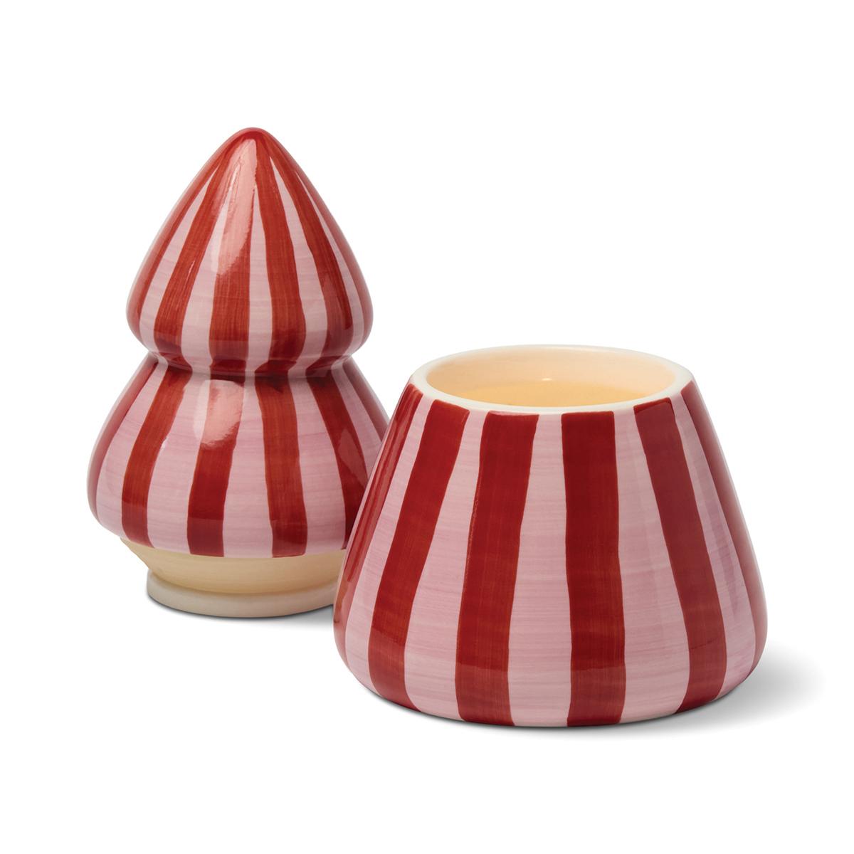Red and pink striped tree candle with its top lifted off and set beside the base, showing the wax.