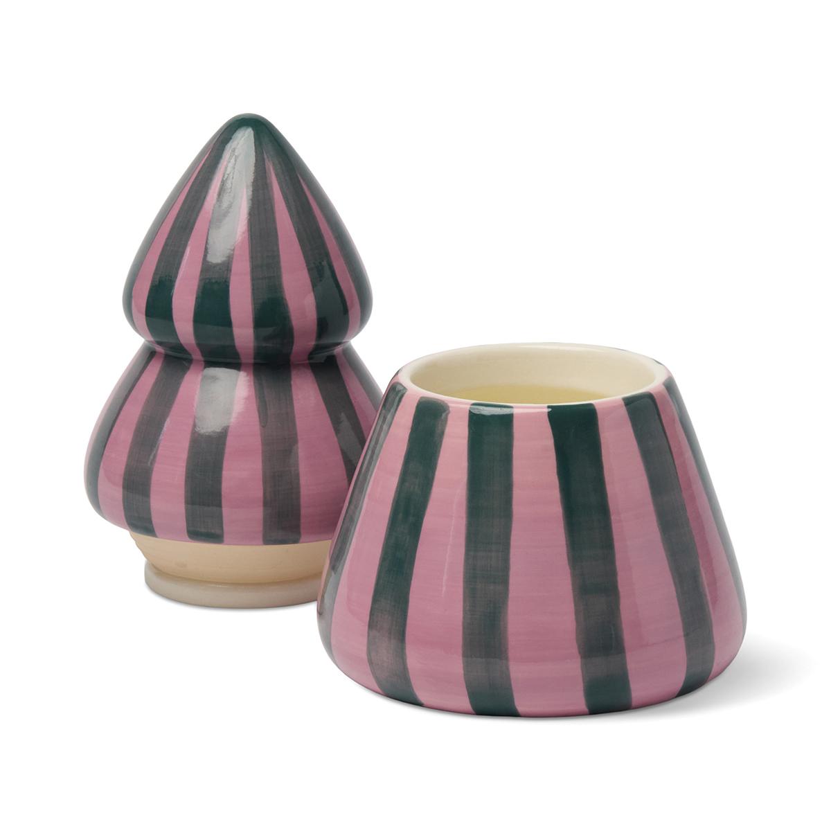 Pink and green striped tree candle with its top lifted off and set beside the base, showing the wax.
