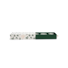 Cream sleeve printed with green pine trees, slid back to show three ribbed candles in a green drawer: two speckled mercury glass, one frosted.