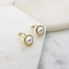 Gold freshwater pearl swirl clip-on earrings angled to show the clip back