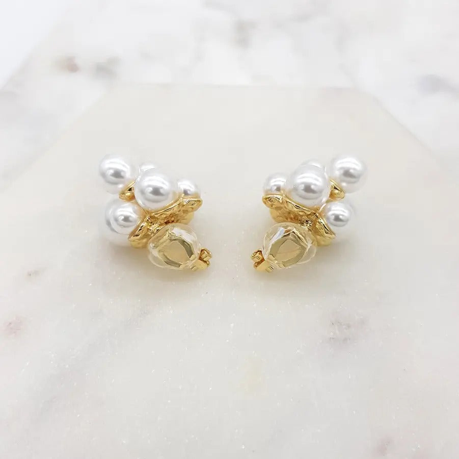 Pearl cluster clip-on earrings turned to show the gold clip fastening