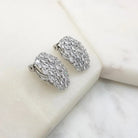 Silver oval cubic zirconia clip-on earrings angled to show the clip fastening