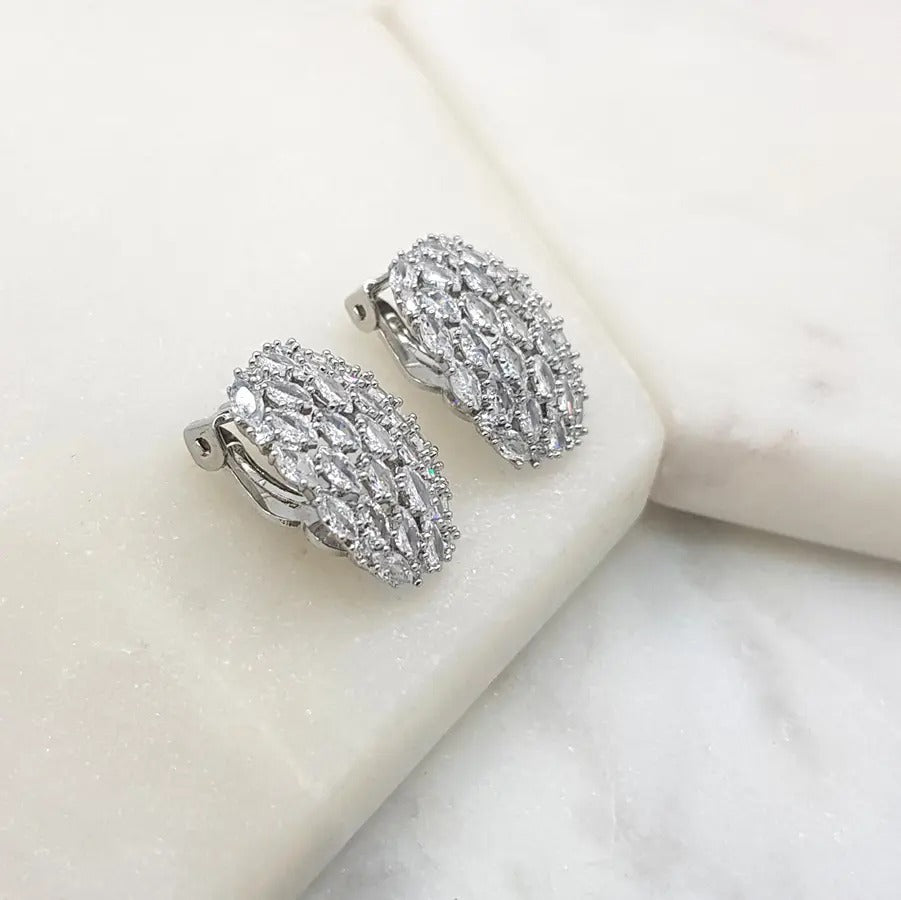 Silver oval cubic zirconia clip-on earrings angled to show the clip fastening
