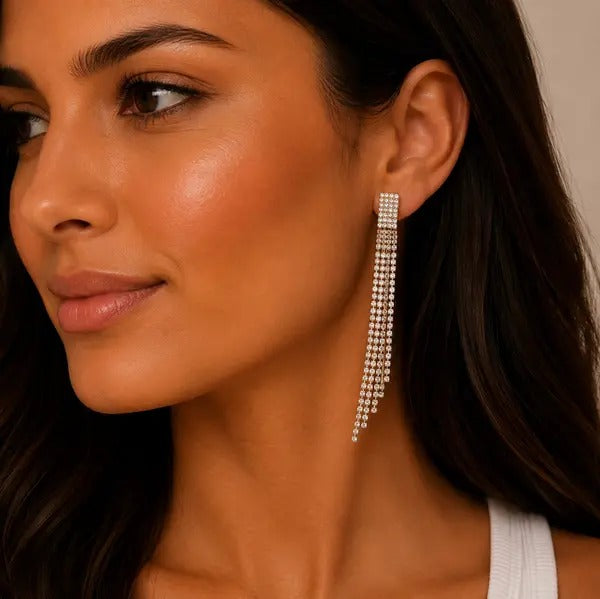 Model wearing a long silver-tone crystal fringe clip-on earring