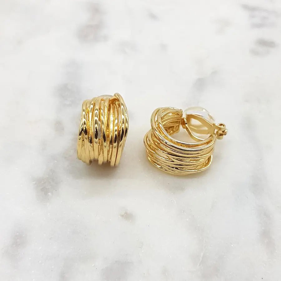 Gold ribbed hoop clip-on earrings turned to show the clip fastening