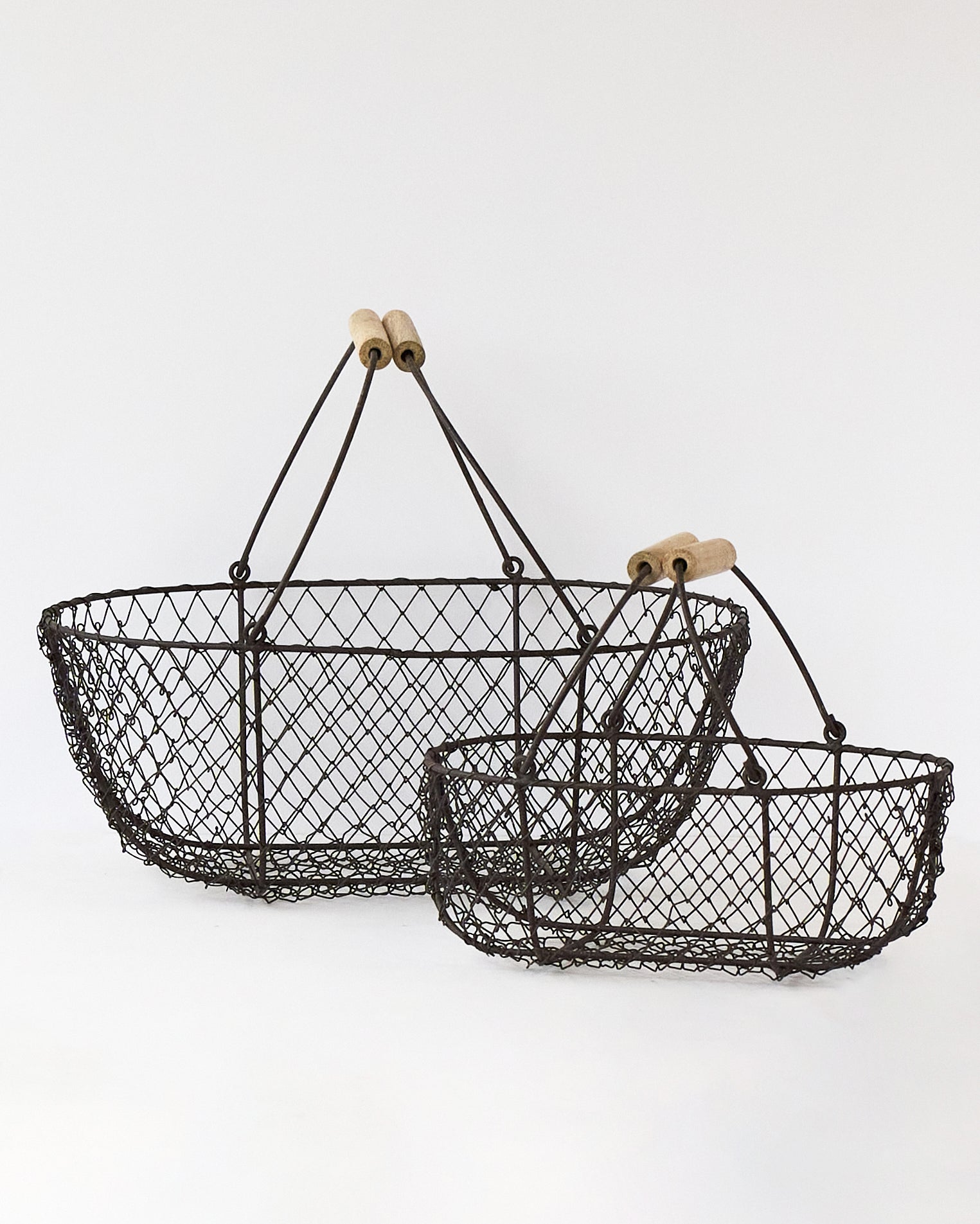 Large and small French potager wire baskets nested together, showing the wooden-grip handles