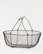Large French potager wire basket with its folding handles raised