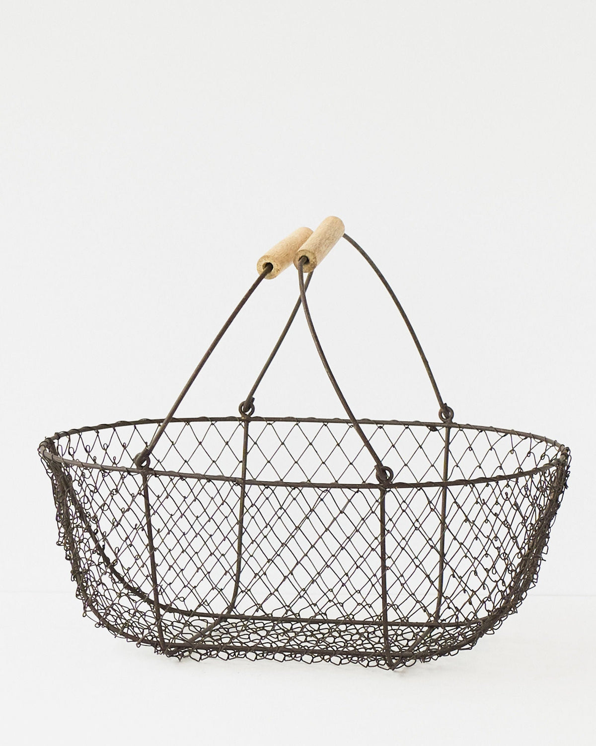 Large French potager wire basket with its folding handles raised