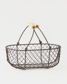 Small French potager wire basket with its folding handles raised