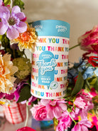 Thank You rocky road gift cylinder among pink and blue flowers