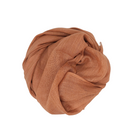 Beauty in Bamboo scarf in a coppery rust-brown, coiled into a round bundle