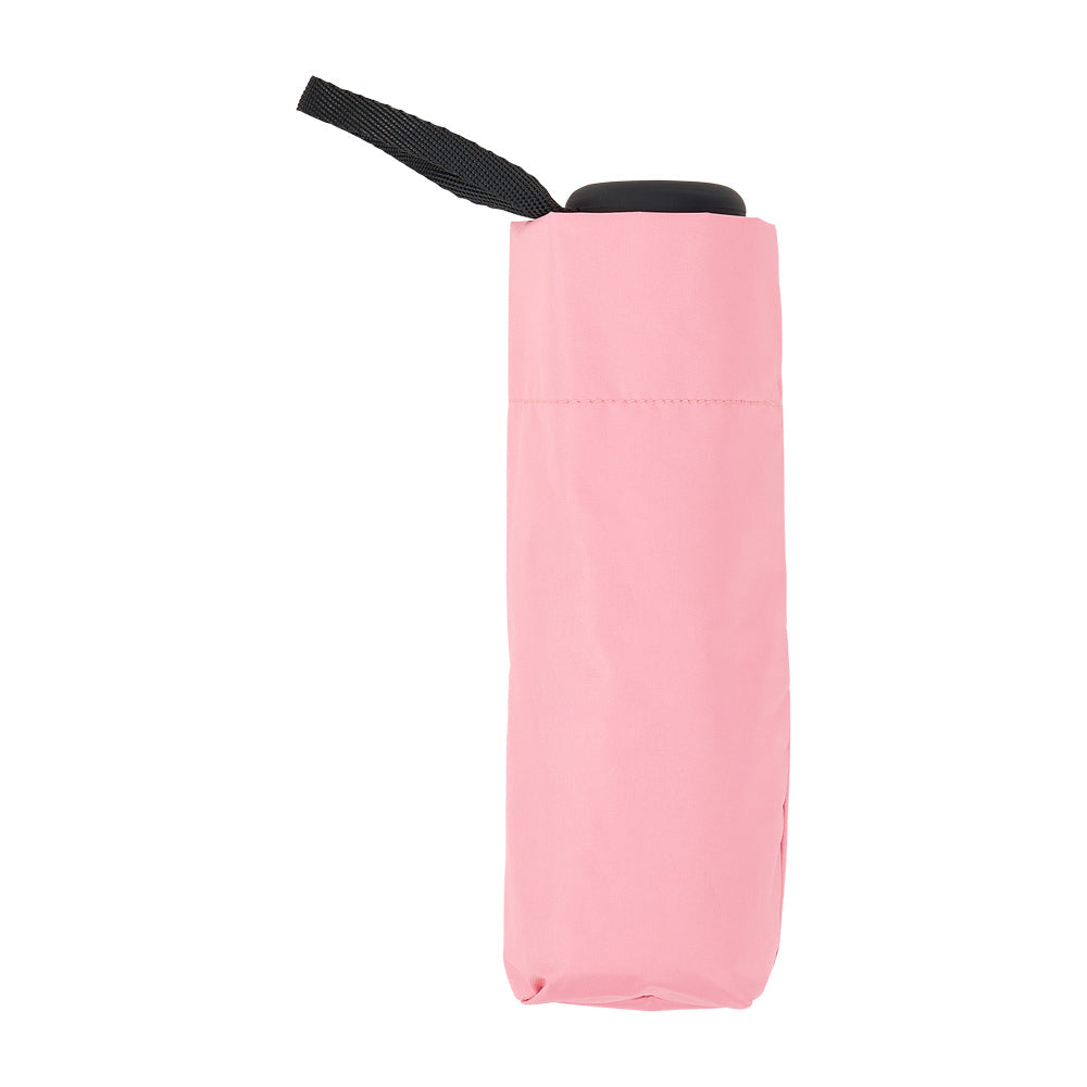 Pale pink folded umbrella standing upright with a black handle and wrist strap.