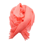 Beauty in Bamboo scarf in Coral, a vivid pink-orange, twisted into a loose knot