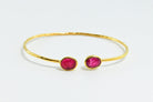 Euro Gold cuff bangle with two ruby-pink oval gems facing each other