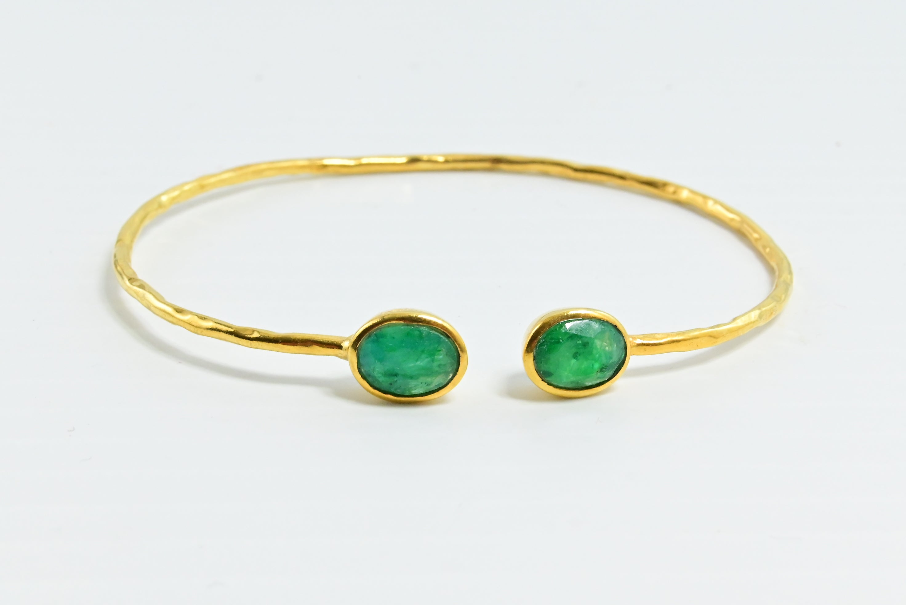 Euro Gold cuff bangle with two emerald-green oval gems