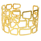 Wide gold cuff bangle cut into an open lattice of irregular rectangles