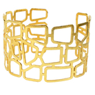 Wide gold cuff bangle cut into an open lattice of irregular rectangles