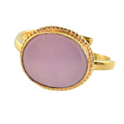 Gold ring with a smooth oval soft lilac stone in a beaded bezel