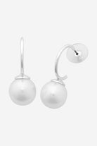 Silver curved hoop earrings, each finished with a large white shell pearl.