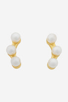Gold ear-climber studs, each set with three graduated white pearls.