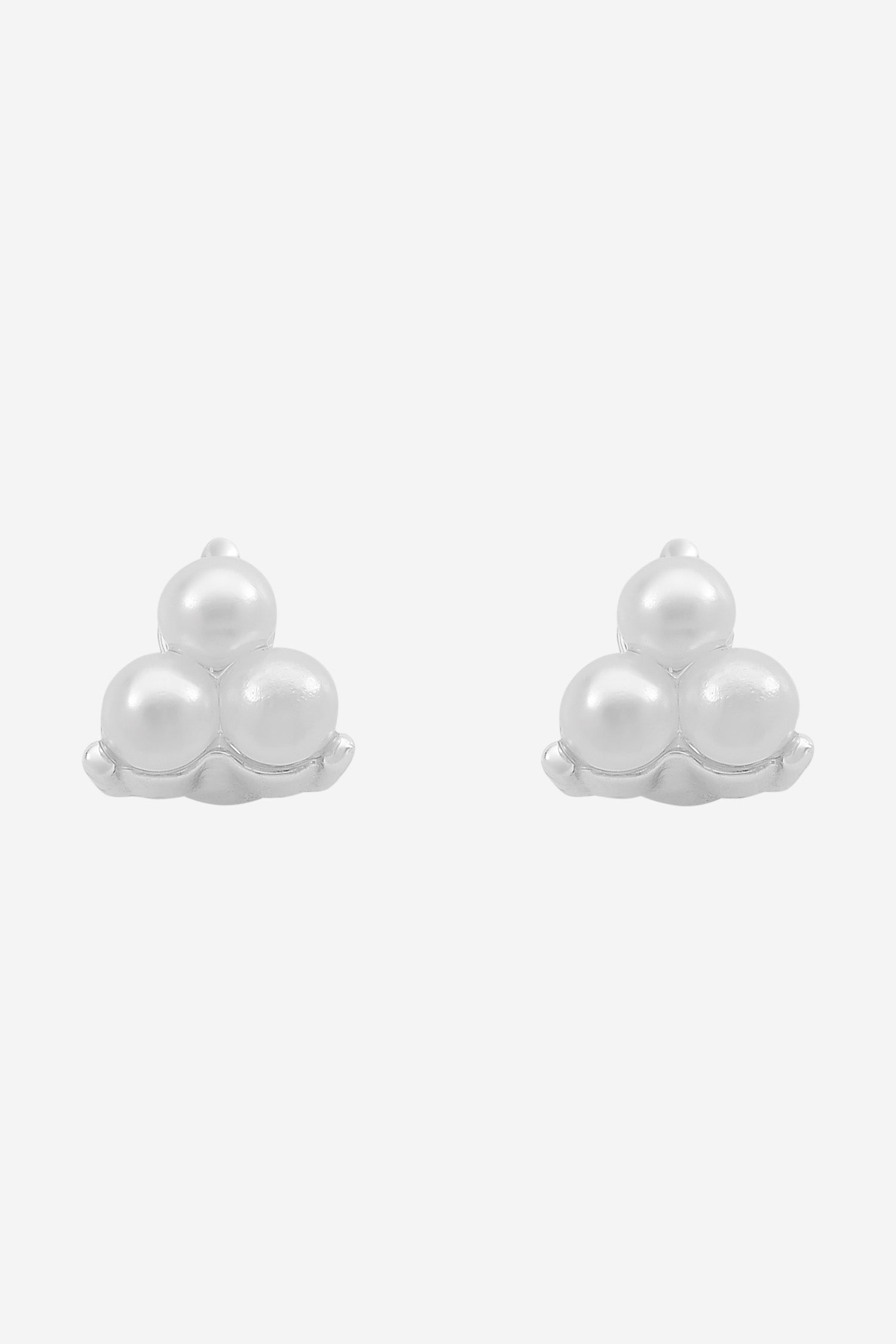 Silver stud earrings, each a small trio of white pearls.