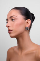 Model in profile wearing the Chloe silver organic-shape earring.