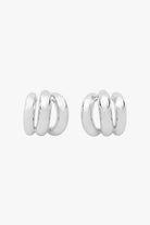 Silver triple-hoop earrings that create a layered look from a single post.