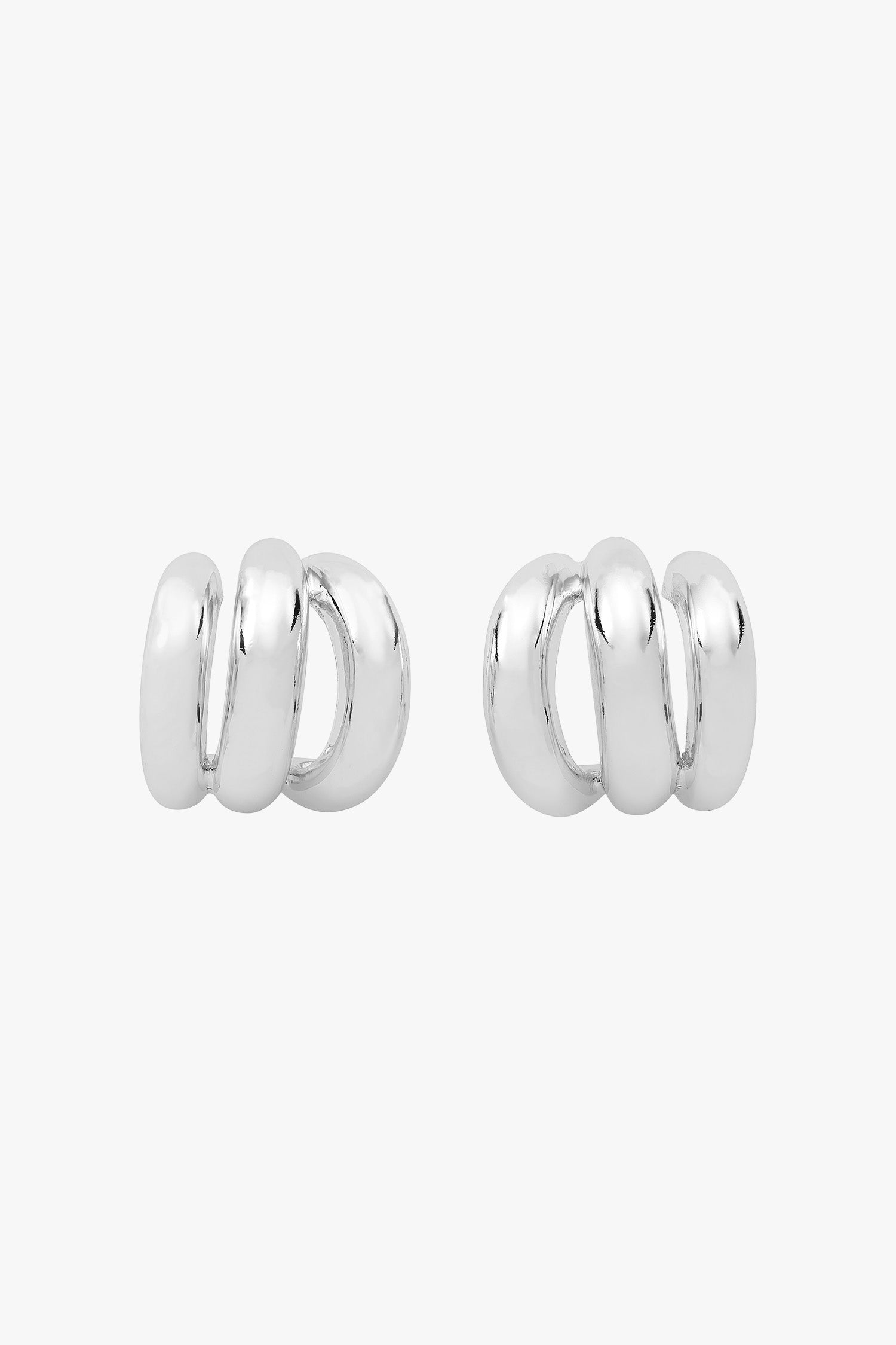 Silver triple-hoop earrings that create a layered look from a single post.