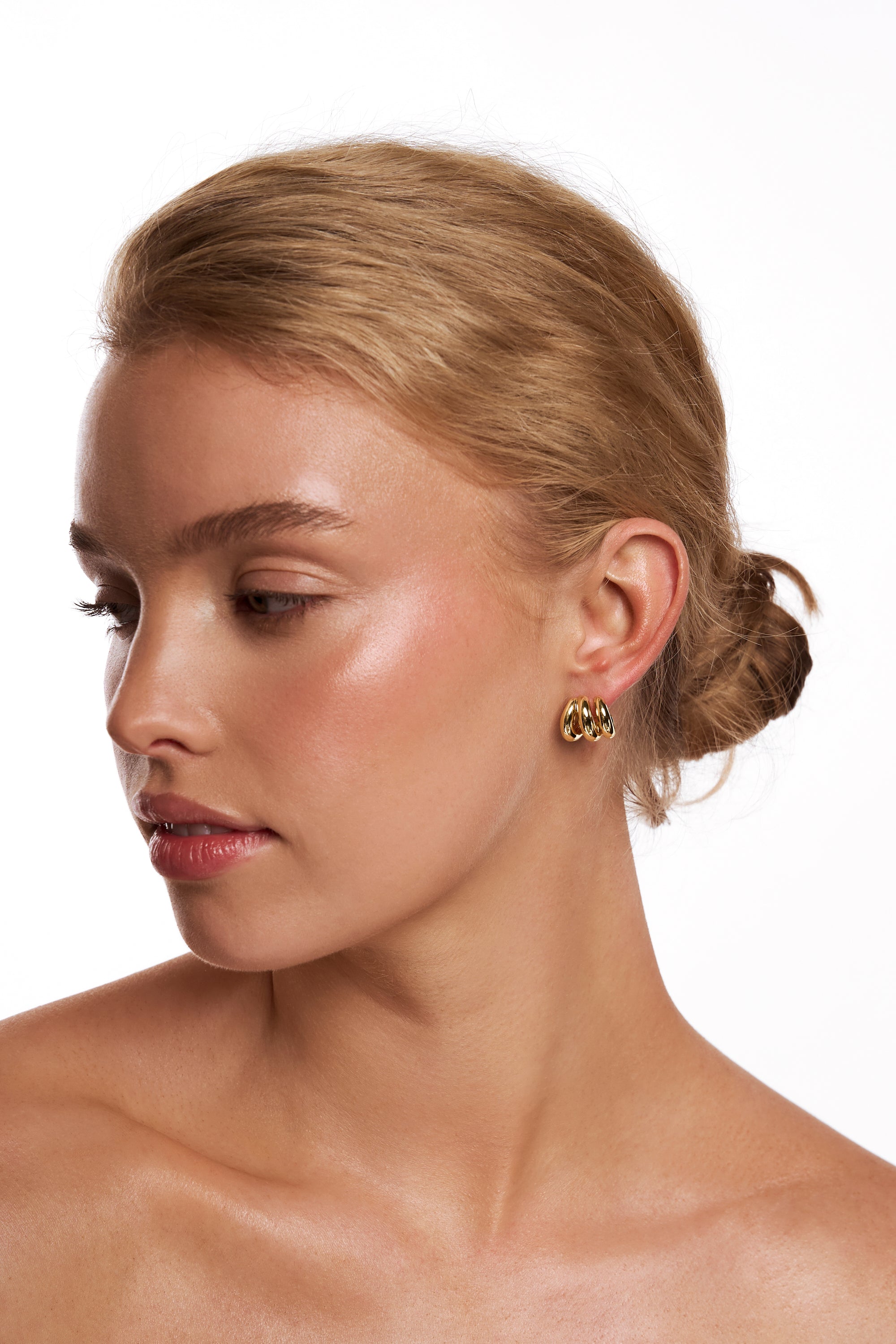 Model wearing the Teddie gold triple hoop.