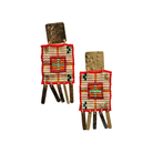 Pair of beaded earrings with brushed gold tabs above cream and red woven panels with dark fringing.