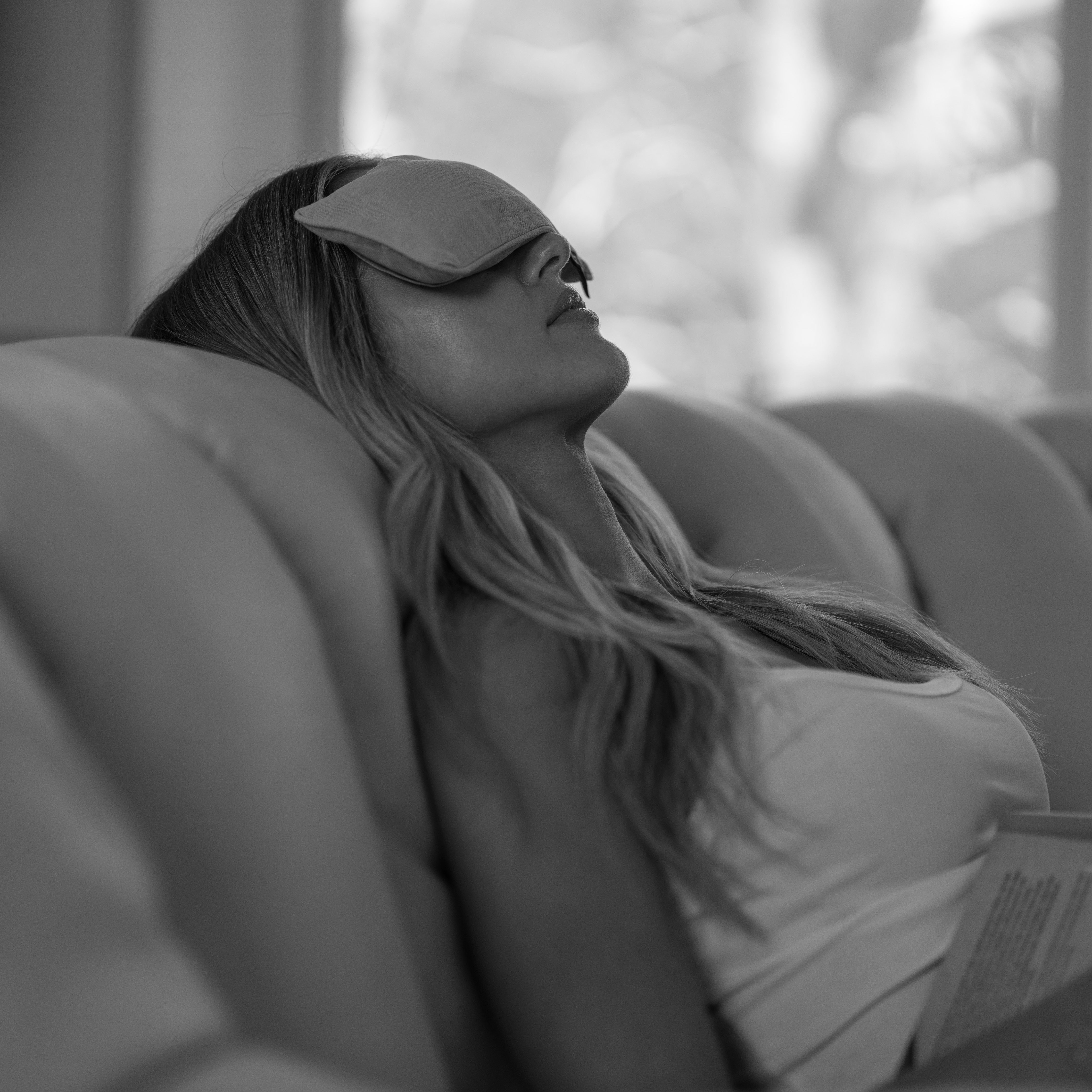 Woman reclining with a Salus aromatherapy eye pillow resting over her eyes