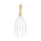 The Head Massager features a wooden handle and flexible wire prongs with black bead tips, designed to gently stimulate nerve endings and acupressure points. Shown on a white background.
