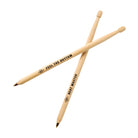The pair of drumstick pens crossed on a white background, showing their engraved slogans and pen tips