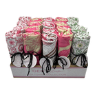 Geobloom tea towel counter display box filled with rolled pink, cream and green printed towels