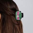 The beaded AMORE claw clip worn in brown hair, side view.