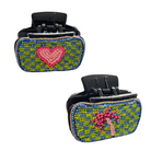 Two black claw hair clips in blue and green beadwork, one with a pink heart and one with a palm tree.