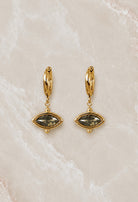 Gold huggie hoop earrings with an olive-green marquise stone drop set in a beaded gold frame