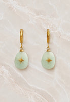 Gold huggie hoop earrings with a pale green aventurine oval stone drop inlaid with a small gold star