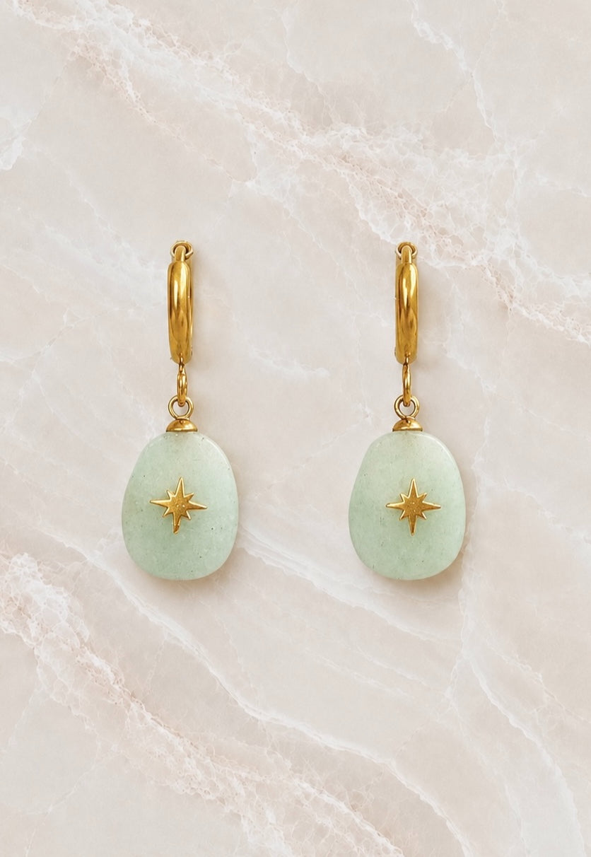 Gold huggie hoop earrings with a pale green aventurine oval stone drop inlaid with a small gold star