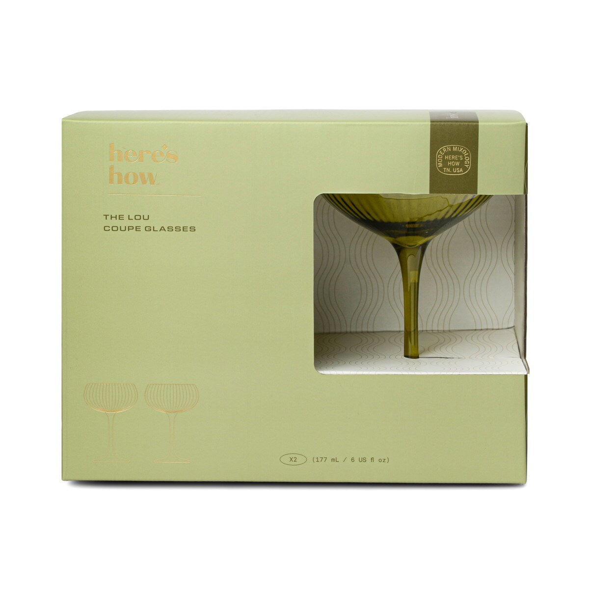 The same box from the front, the olive coupe standing in the window.