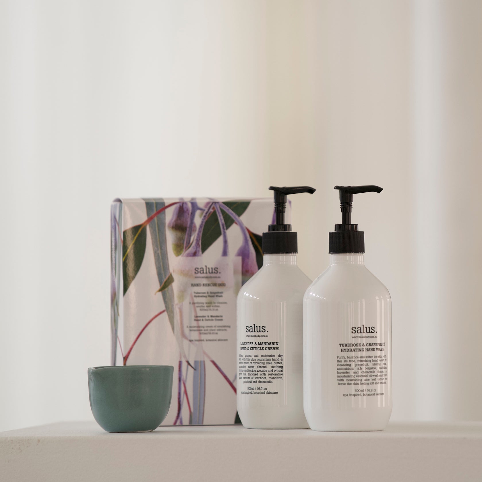 Salus Hand Rescue Duo pump bottles and gumnut print gift box beside a small green bowl