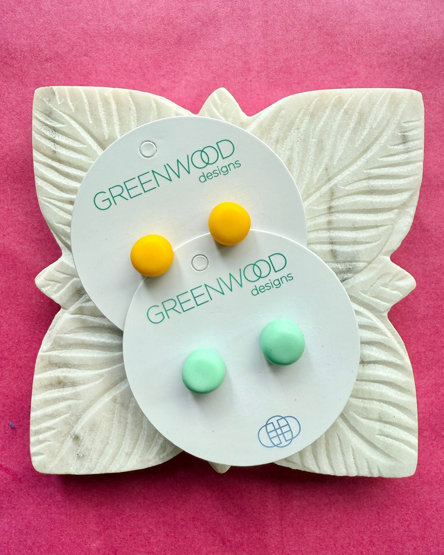 Round resin studs in Yellow and Mint on two overlapping cards, on a carved white leaf dish.