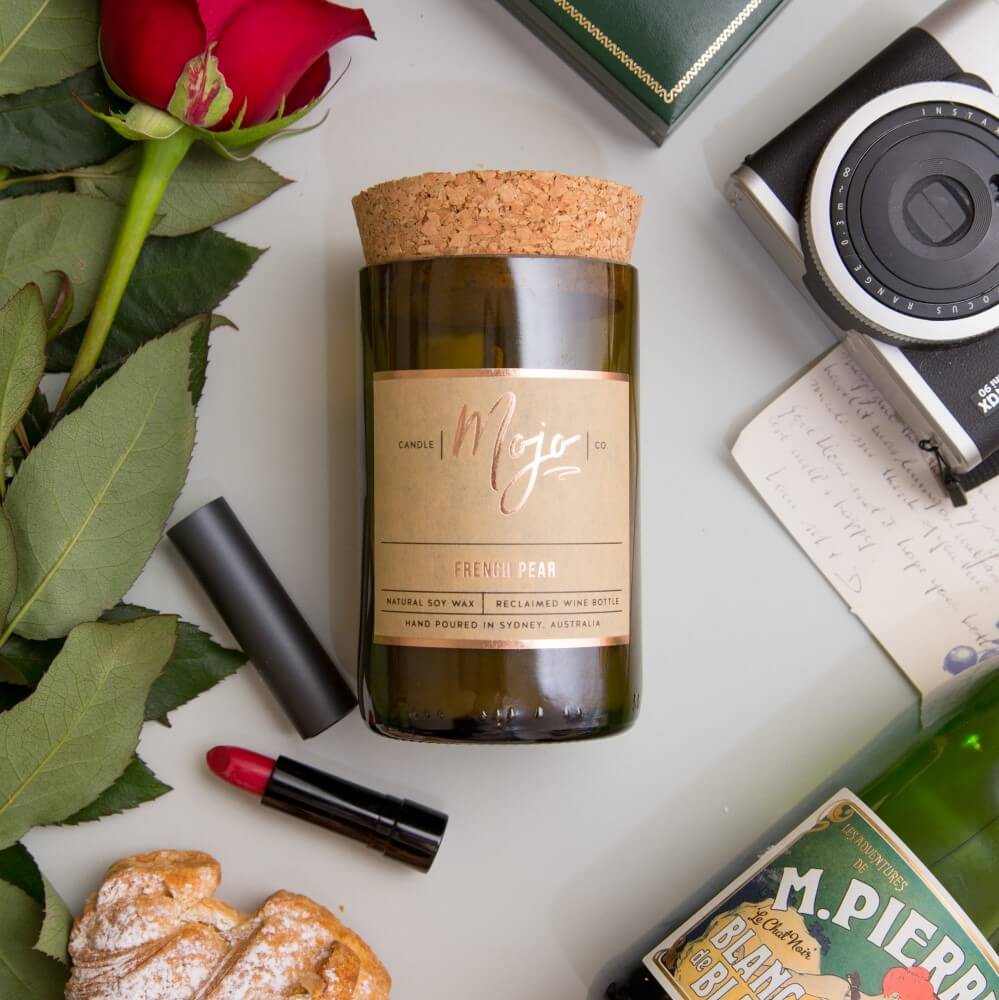 Rose, Pepper & Blackmint candle styled with a red rose, lipstick and vintage camera