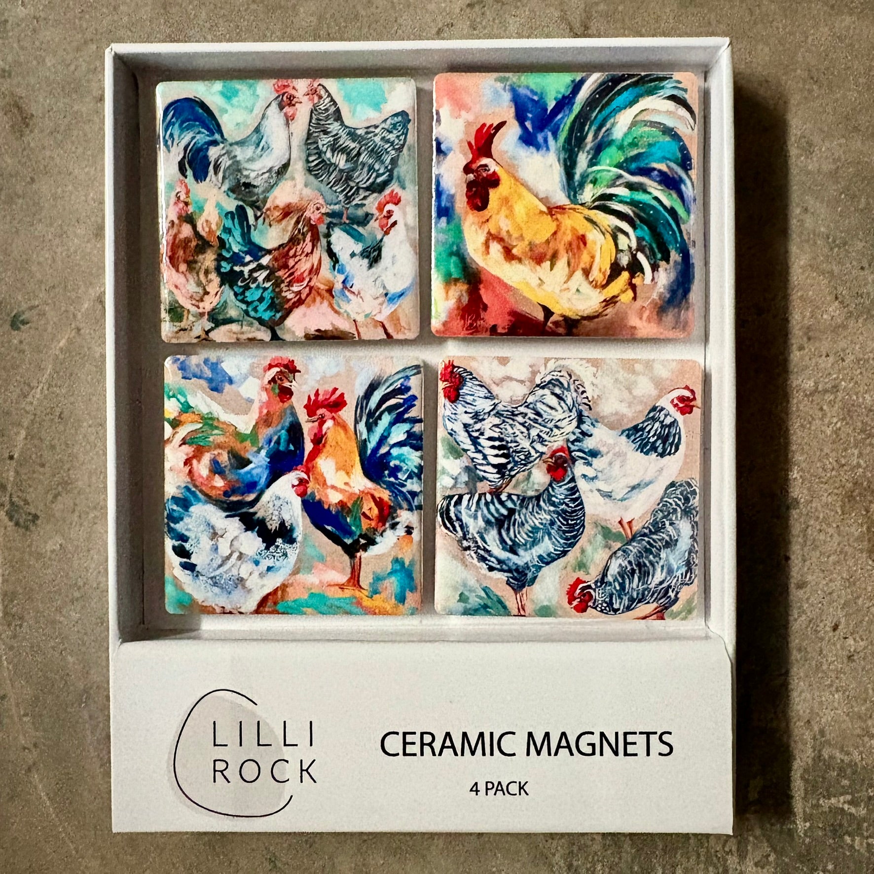 Boxed set of four ceramic magnets painted with colourful chickens and roosters