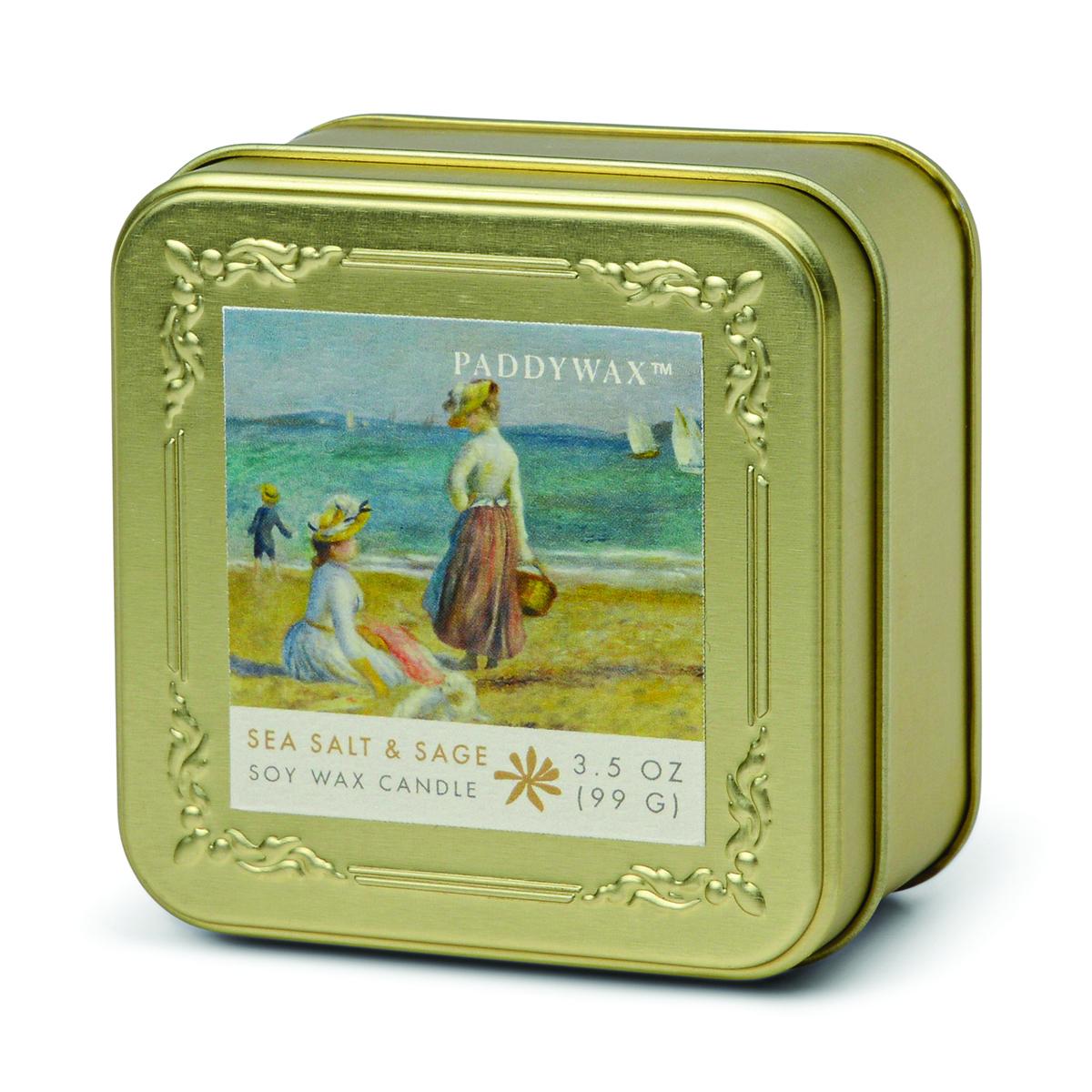 Gold-toned embossed square tin candle printed with Renoir's Figures on the Beach, labelled Sea Salt & Sage soy wax candle, 3.5 oz.