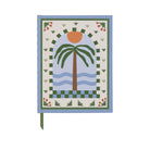 A Dopo journal with a palm tree, orange sun and blue waves inside a green chequered arch
